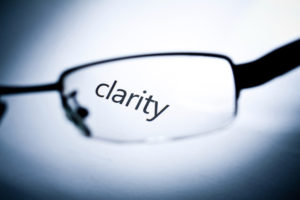 Word "clarity" viewed from a glasses.