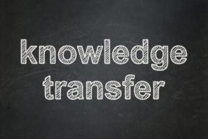 Education concept: text Knowledge Transfer on Black chalkboard background, 3d render